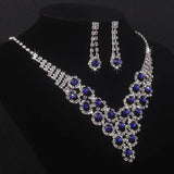 High end and elegant bridal accessories, including a necklace and a pair of earrings, set in blue, red, and purple. Bridal acces