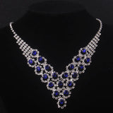 High end and elegant bridal accessories, including a necklace and a pair of earrings, set in blue, red, and purple. Bridal acces