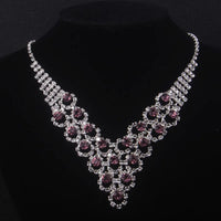 High end and elegant bridal accessories, including a necklace and a pair of earrings, set in blue, red, and purple. Bridal acces