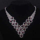 High end and elegant bridal accessories, including a necklace and a pair of earrings, set in blue, red, and purple. Bridal acces