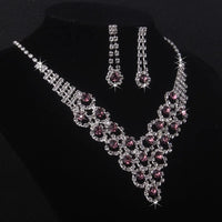 High end and elegant bridal accessories, including a necklace and a pair of earrings, set in blue, red, and purple. Bridal acces