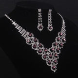 High end and elegant bridal accessories, including a necklace and a pair of earrings, set in blue, red, and purple. Bridal acces