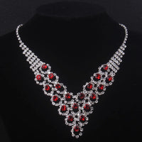 High end and elegant bridal accessories, including a necklace and a pair of earrings, set in blue, red, and purple. Bridal acces