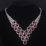 High end and elegant bridal accessories, including a necklace and a pair of earrings, set in blue, red, and purple. Bridal acces