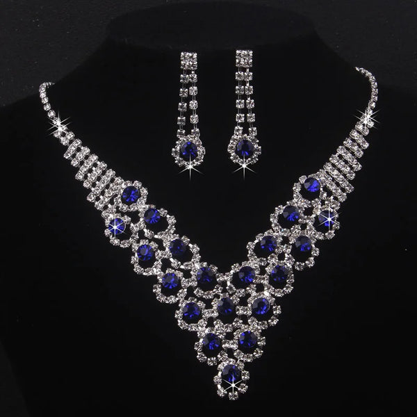High end and elegant bridal accessories, including a necklace and a pair of earrings, set in blue, red, and purple. Bridal acces