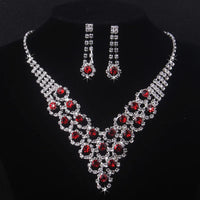 High end and elegant bridal accessories, including a necklace and a pair of earrings, set in blue, red, and purple. Bridal acces