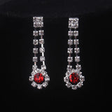 High end and elegant bridal accessories, including a necklace and a pair of earrings, set in blue, red, and purple. Bridal acces